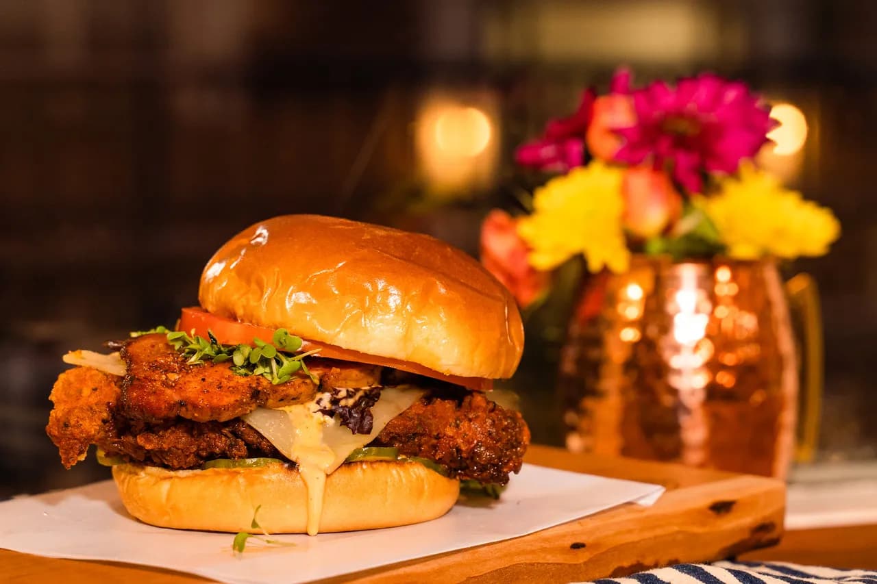 New Hope For Chicken — panko-crusted chicken with house Canadian bacon, Havarti, tomato, and hot sauce aioli on a brioche bun.
